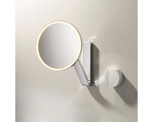 Runder Wandspiegel mit Beleuchtung und Bedienungselement an der Wand