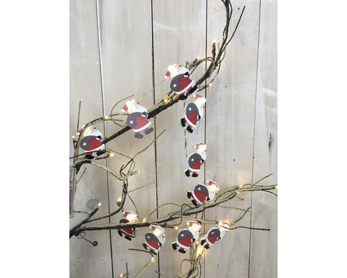 Dekorativer Weihnachtszweig mit Santa Claus Figuren und Lichtern für festliche Beleuchtung