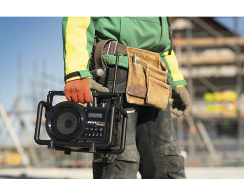 Artisan tenant une radio de chantier de la marque Perfectpro.