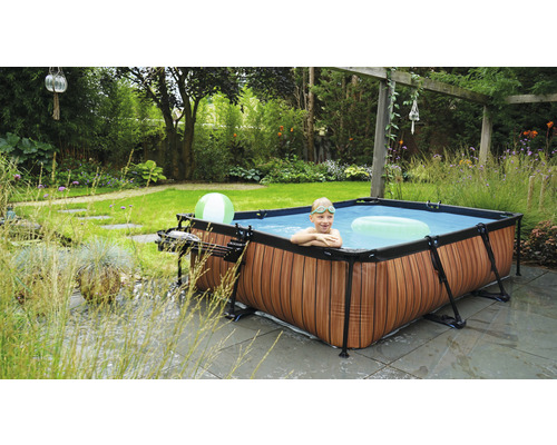 Piscine hors sol dans le jardin avec un enfant dans l''eau et décoration de jardin