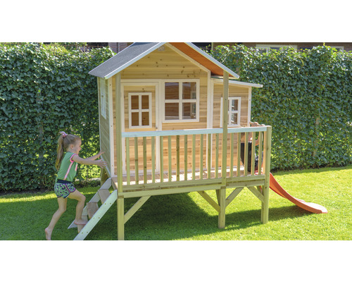 Maisonnette en bois avec toboggan et escalier dans le jardin