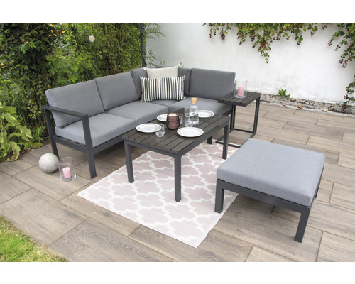 Ensemble de salon de jardin avec canapé d''angle, table et tabouret sur une terrasse