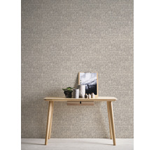 Heller Raum mit beiger Textiltapete, Holztisch, Pflanze und Bild