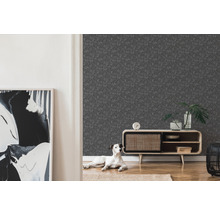 Ein Wohnzimmer mit einer grauen Tapete mit Muster, einem Holzschrank und einem Hund.
