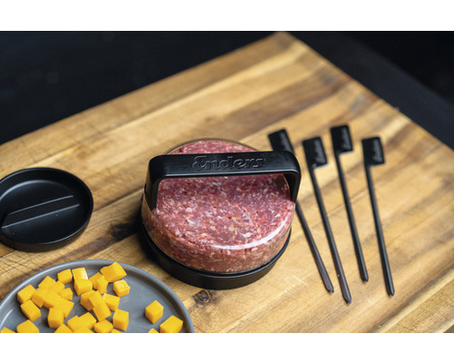 Enders Burgerpresse mit Fleisch und Burgerbrandeisen auf einem Holzbrett
