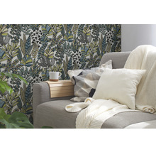Wohnzimmer mit Sofa, Kissen, Decke und floraler Tapete