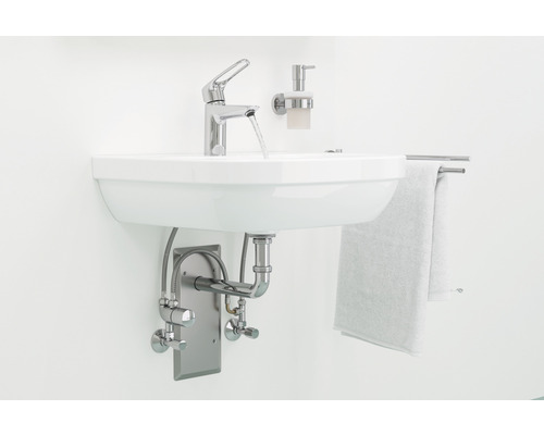 Lavabo avec robinet, distributeur de savon et porte-serviettes dans la salle de bain