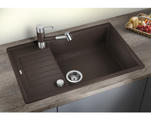 Braunes Spülbecken mit Abtropffläche und Armatur auf einer Arbeitsplatte.