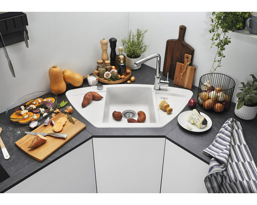 Évier d''angle avec robinetterie et divers aliments dans une cuisine
