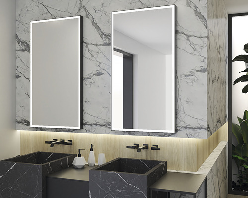 Salle de bain avec deux miroirs éclairés et lavabos en marbre