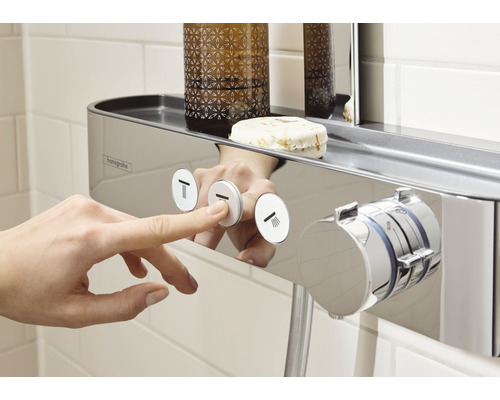 Nahaufnahme einer Hand, die einen Knopf an einer Duscharmatur mit Ablage drückt