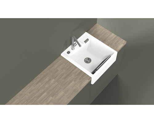 Vue de dessus d''un évier de cuisine blanc avec robinet et égouttoir sur un plan de travail.