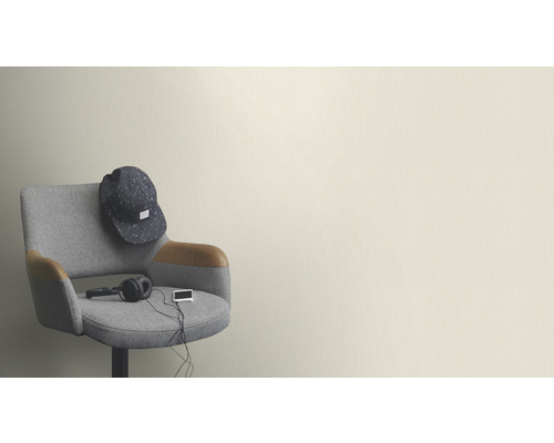 Chaise grise avec accessoires devant un mur