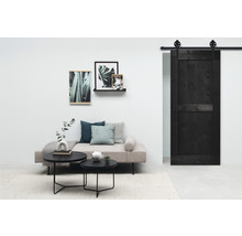 Salon avec canapé, table et porte coulissante noire