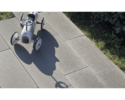 Graue Terrassenplatten mit Spielzeugauto
