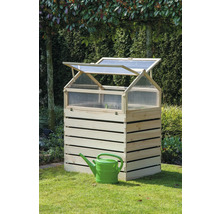 Jardinière surélevée en bois avec arrosoir dans le jardin