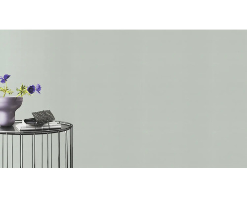 Dekorative Szene mit Blumen, Vase, Buch und Handtasche auf einem Beistelltisch