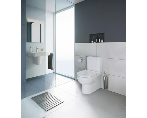 Salle de bain moderne avec toilettes, lavabo et douche.