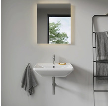 Salle de bains moderne avec lavabo, miroir lumineux et porte-serviettes.