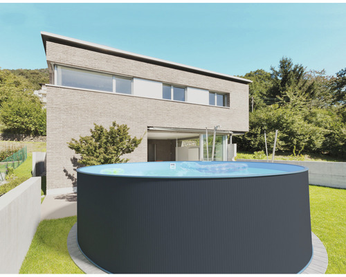 Piscine hors sol ronde dans le jardin devant une maison