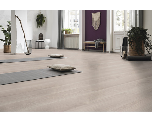 Heller Raum mit Laminatboden, Yogamatten und Dekorationen für Yoga und Meditation