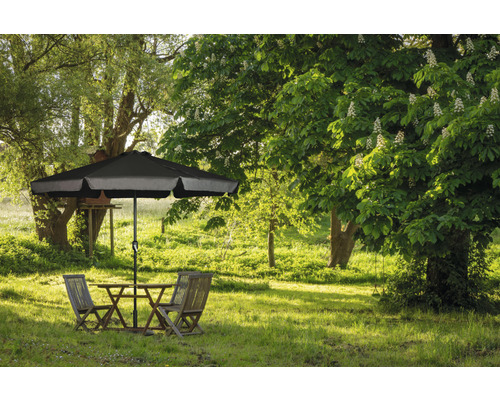 Scène de jardin avec table, chaises et parasol sur une pelouse verte