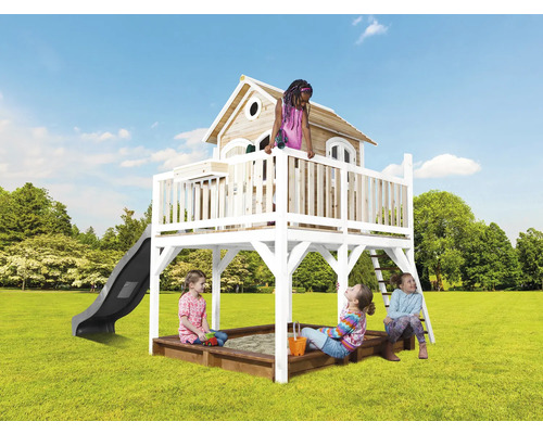 Aire de jeux avec cabane, toboggan, échelle et bac à sable dans le jardin avec des enfants qui jouent