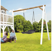 Aire de jeux avec balançoire et deux enfants dans le jardin.