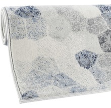 Tapis avec motif géométrique, partiellement enroulé