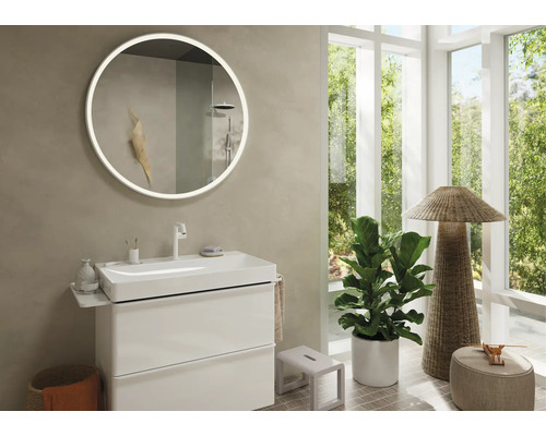 Modernes Badezimmer mit rundem Spiegel, Waschbeckenunterschrank und Dekoration