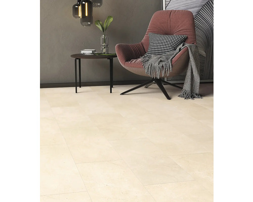 Carrelage de sol beige dans un salon avec fauteuil et table d''appoint.