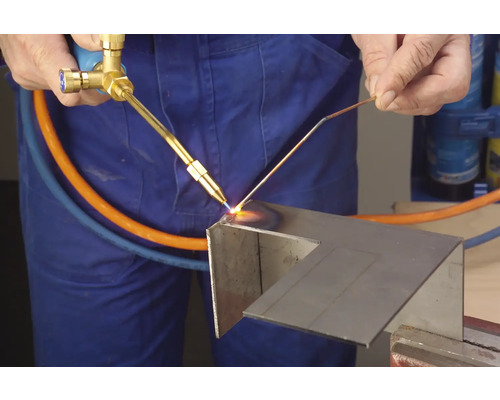 Un artisan utilise un chalumeau pour travailler le métal.
