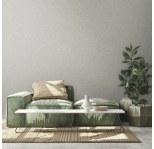 Wohnzimmer mit modularem Sofa, Beistelltisch, Zimmerpflanze und Teppich