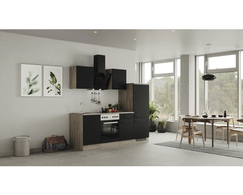 Cuisine moderne avec armoires noires et touches de bois dans une pièce lumineuse.