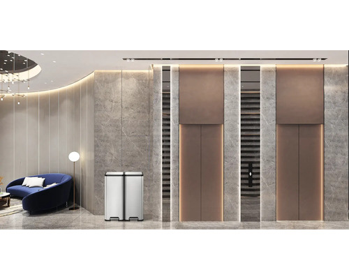 Poubelle à deux compartiments en acier inoxydable dans un espace au design moderne.