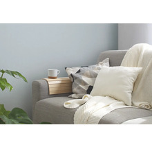 Graues Sofa mit Kissen, Decke und Ablage
