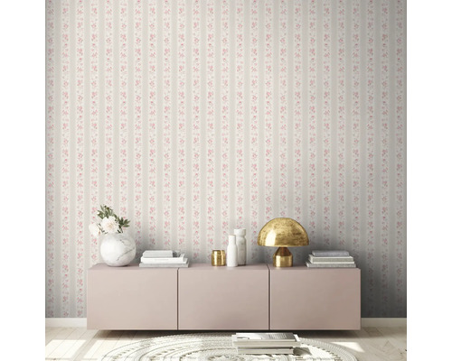 Wohnzimmer mit gestreifter Blumentapete, Kommode, Tischleuchte und Dekoration