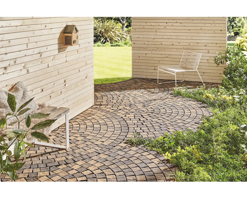 Aussenbereich mit Pflastersteinen, Sitzgelegenheit und Holzwand