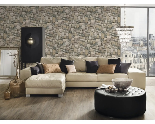 Salon avec canapé d''angle, papier peint imitation pierre, pouf ottoman, armoire et décorations.