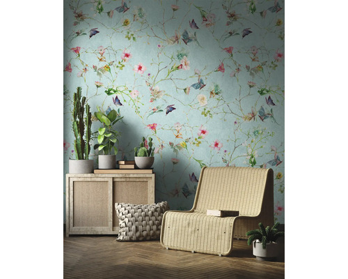 Wohnraum mit floraler Tapete, Sessel und Zimmerpflanzen für ein harmonisches Ambiente