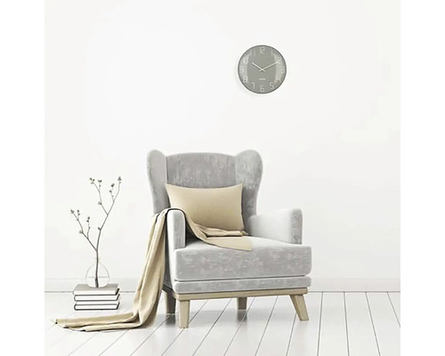 Wohnzimmer Szene mit Sessel, Kissen, Decke, Wanduhr und Dekoration