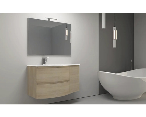 Salle de bains avec lavabo, miroir et baignoire îlot.