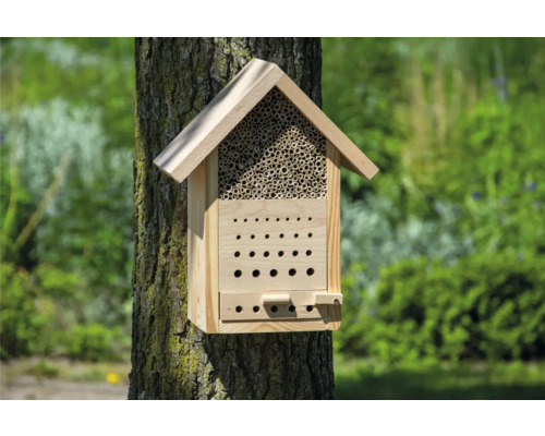 Insektenhotel aus Holz an einem Baumstamm