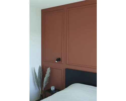 Schlafzimmer mit Wandpaneelen, Bett, Nachttisch und Wandleuchte