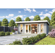 Maison de jardin moderne avec bureau dans un jardin soigné.