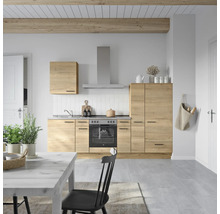 Cuisine claire avec surfaces en bois, évier, cuisinière et hotte aspirante dans une pièce lumineuse.