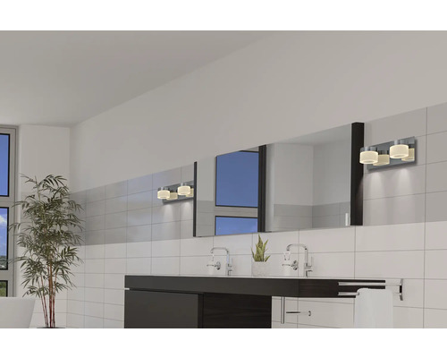 Helles Badezimmer mit Doppelwaschbecken, großem Spiegel und Wandleuchten