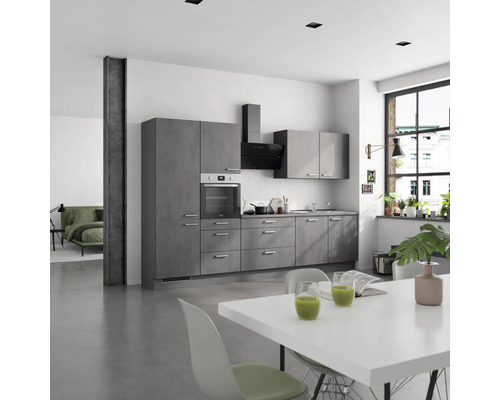 Cuisine moderne avec armoires grises, hotte aspirante et table à manger blanche.
