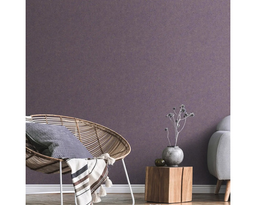 Wohnzimmer mit Rattansessel, Holztisch und Vliestapete