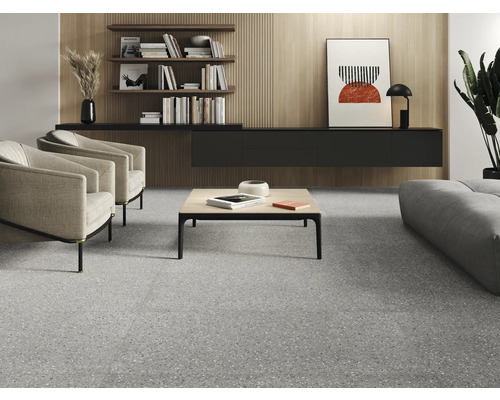 Salon avec sol en terrazzo, fauteuils, table basse et étagères